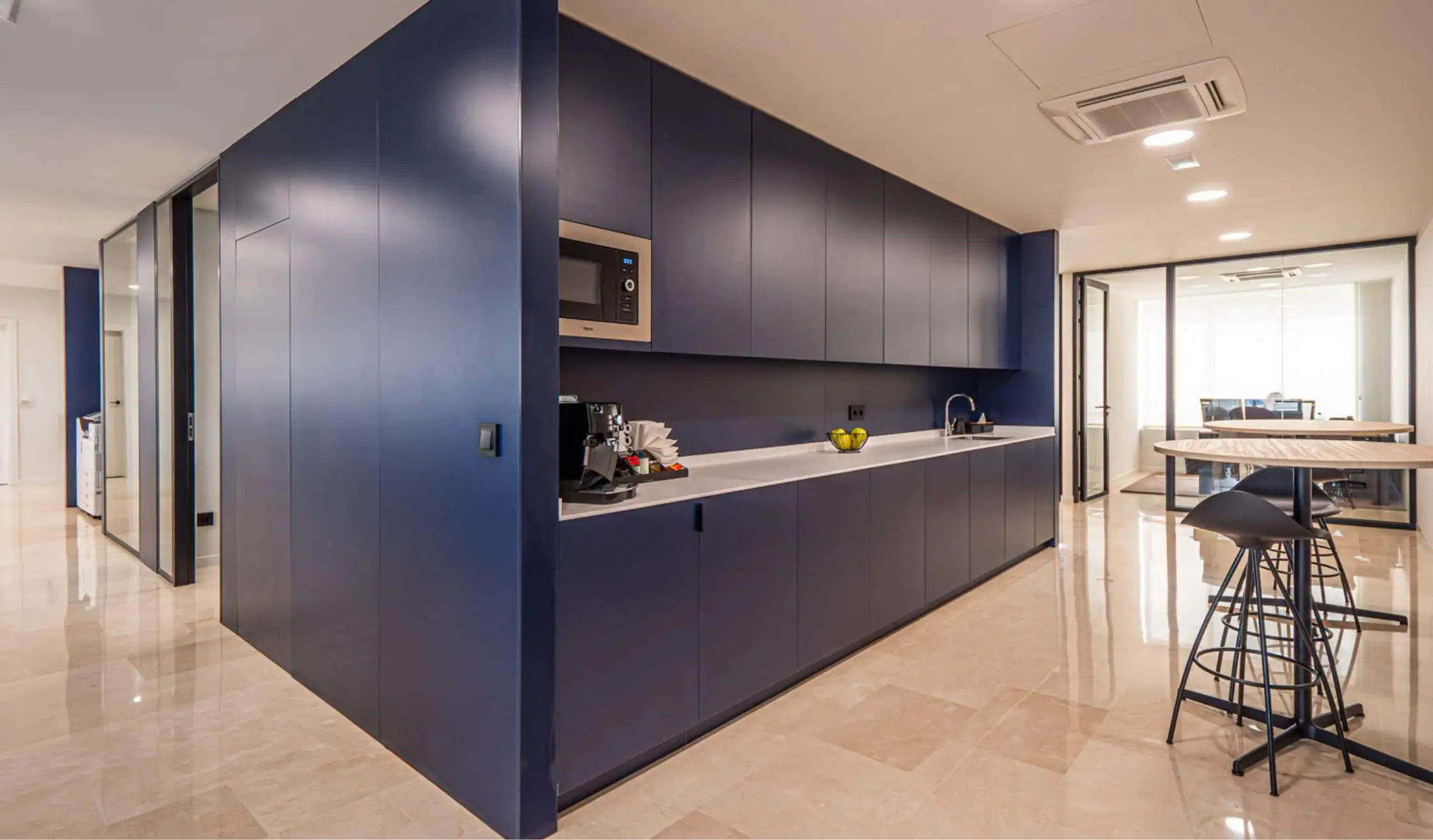 Zona de office en oficina fabricado en carpintería a medida de color azul